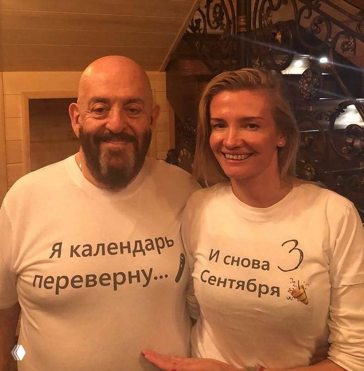 Неофициальное фото Михаила Шуфутинского и Светланы Уразовой в повседневной обстановке: они улыбаются в футболках с надписями, тёплая домашняя атмосфера.