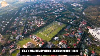 Аэрофотосъёмка района Дигоми в Тбилиси: участок и соседние участки, дорожная сеть, частные дома и открытая панорама города.