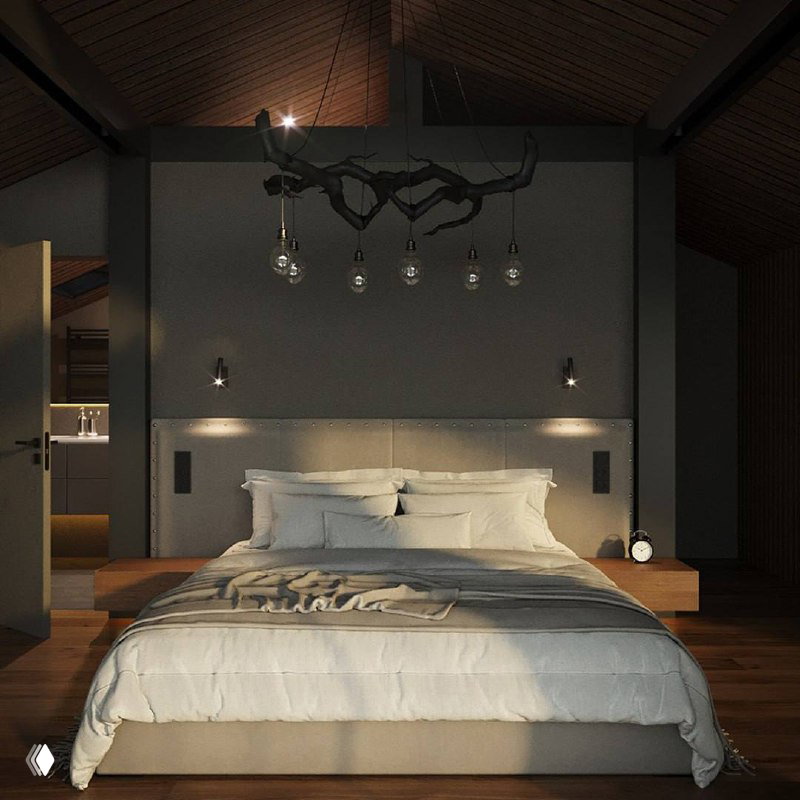 Спальня в тёплых серых тонах: большая кровать с белым постельным бельём, деревянный пол и декоративная подвесная лампа под скатной крышей.