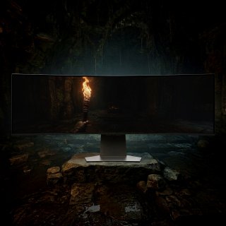 Изогнутый монитор Samsung в тёмной пещере с факелом; на экране подчёркнуты глубокие чёрные, контраст и тонкие детали изображения.