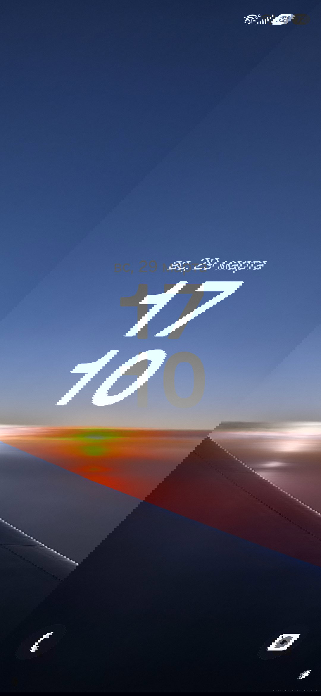 Крупный план розовых цветков на ветке на фоне синего неба — нежная весенняя заставка с естественной текстурой лепестков.