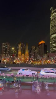 Ночной городской пейзаж с подсветкой зданий и отражениями в воде, проезжающие машины и огни создают эффектное завершение серии фото по Шанхаю.