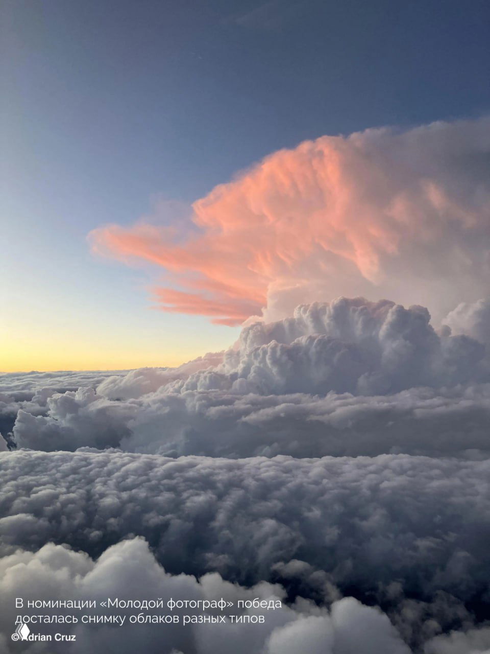 Фотография облаков разного типа из окна самолёта: многослойные кумулюсы на фоне закатного неба с розовым свечением.