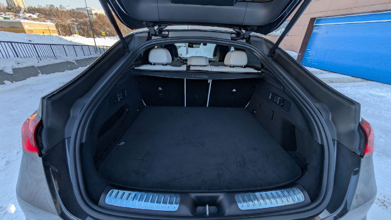 Большой багажник Mercedes GLC 300 Coupe с открытой крышкой, пустое грузовое пространство и защитный порог, интерьер багажника в тёмной отделке