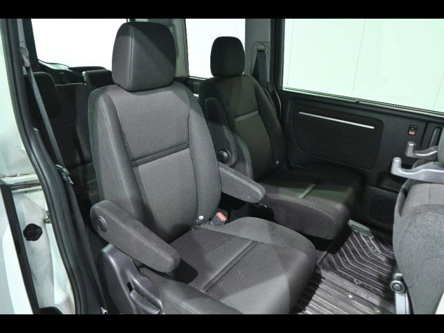 Средний ряд кресел Honda Step Wagon: два отдельных сиденья с подлокотниками, тканевая обивка и достаточное пространство для пассажиров.