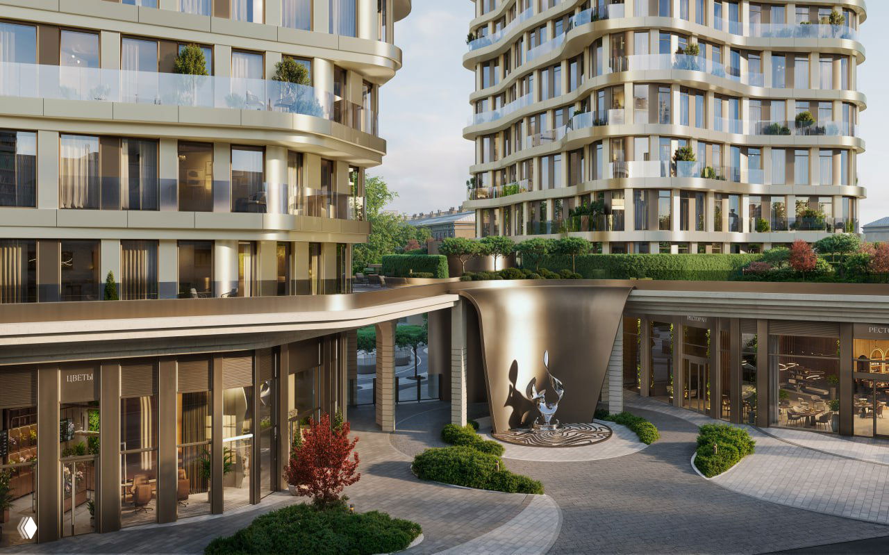 Кадр с входной группой проекта: низкая коммерческая часть, арт-объект в поле зрения и балконы премиальных резиденций выше на фоне неба.