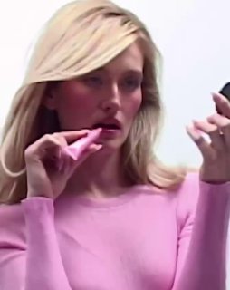 Кадр из видео рекламной кампании: Сара наносит помаду в розовой упаковке, демонстрация нанесения и текстуры продукта.