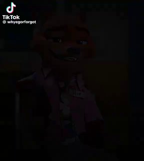 Темный фрагмент видеоклипа с Ником Уайлдом: слабая подсветка, герой в розовой рубашке на фоне интерьера, кадр низкой яркости.