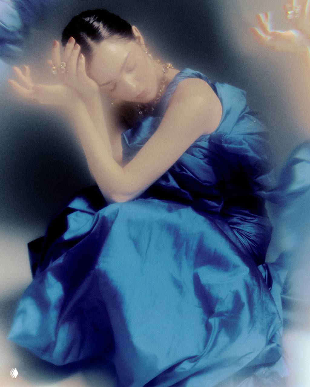 Интимный портрет в мягком свете: женщина в синем платье с расслабленной позой, художественная мягкая обработка и нежная тональность кадра.