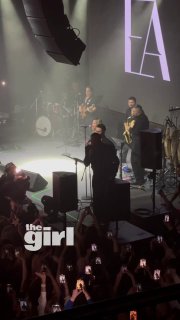 Вид сцены с высоты: Эмре Алтуг, музыканты и саксофонист во время «Bu Kadar Mi», публика держит телефоны и фонарики