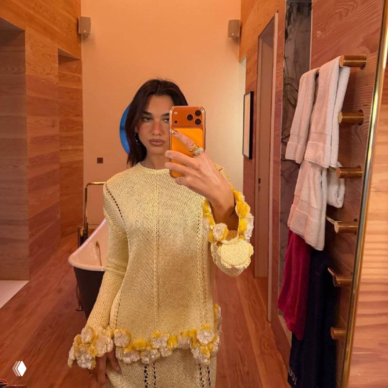 Кадр в примерочной или гримерке: демонстрация яркого маникюра с контрастными цветами, стразами и объёмным декором на ногтях.