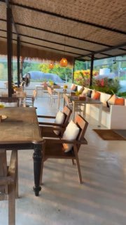 Интерьер ресторана с белыми диванами и деревянными столами: светлое аккуратное пространство, подходящее для ужина с видом.