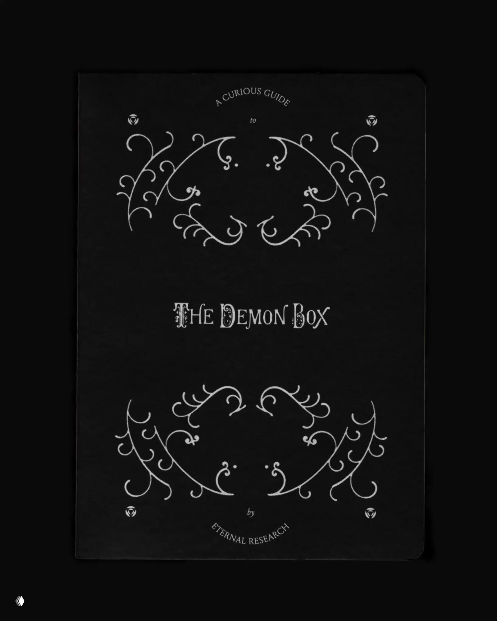 Чёрная обложка с белыми викторианскими орнаментами и заголовком «The Demon Box», оформленная в винтажной типографике от Eternal Research.