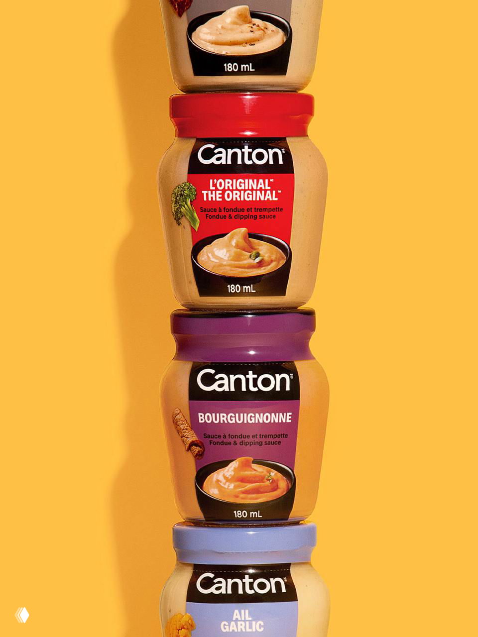 Вертикальная композиция баночек Canton на жёлтом фоне: несколько банок с разноцветными крышками и крупными этикетками нового фирменного стиля.