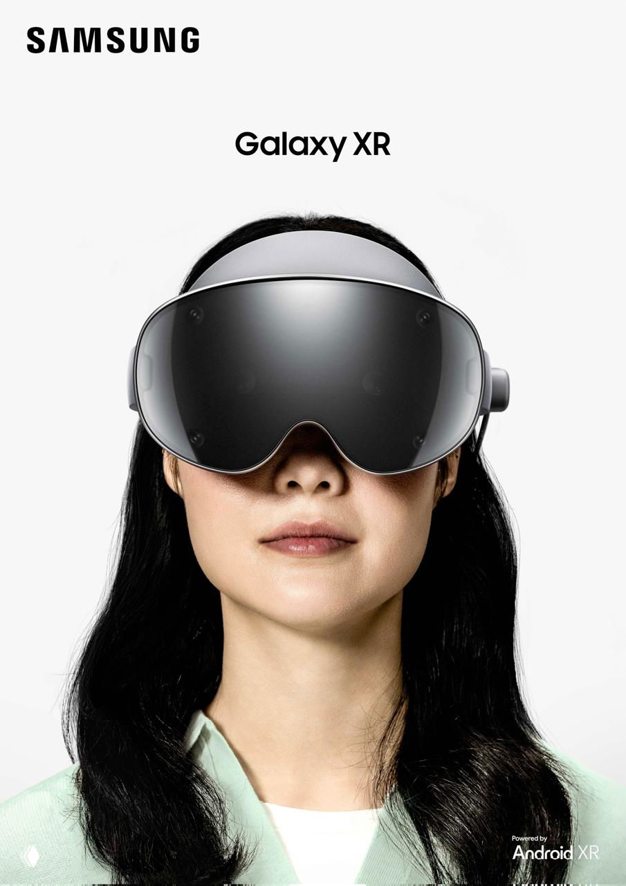 Портрет женщины в VR-шлеме Galaxy XR на светлом фоне; крупный план маски шлема и часть логотипа Samsung в верхней части кадра.