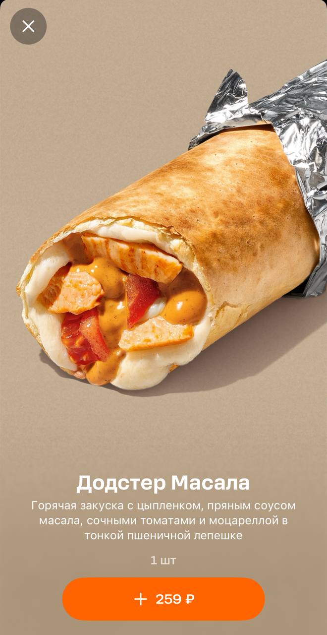 Додстер Масала в разрезе: тонкая пшеничная лепёшка с кусочками цыплёнка, томатами, моцареллой и пряным соусом масала, завернутая в фольгу.