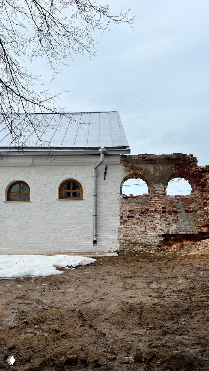 Сочетание отреставрированной белой стены и разрушенной кирпичной ограды в усадебном комплексе Полотняного Завода — контраст прошлого и реставрации