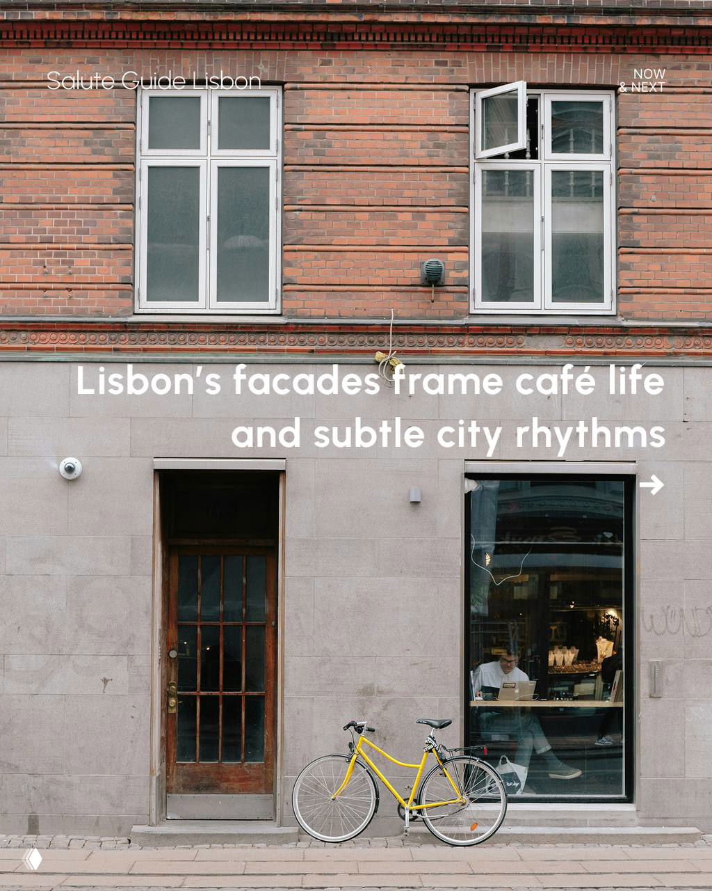 Street-level façade in Lisbon with a yellow bicycle parked outside a café window, brick and stone textures framing everyday city life.
