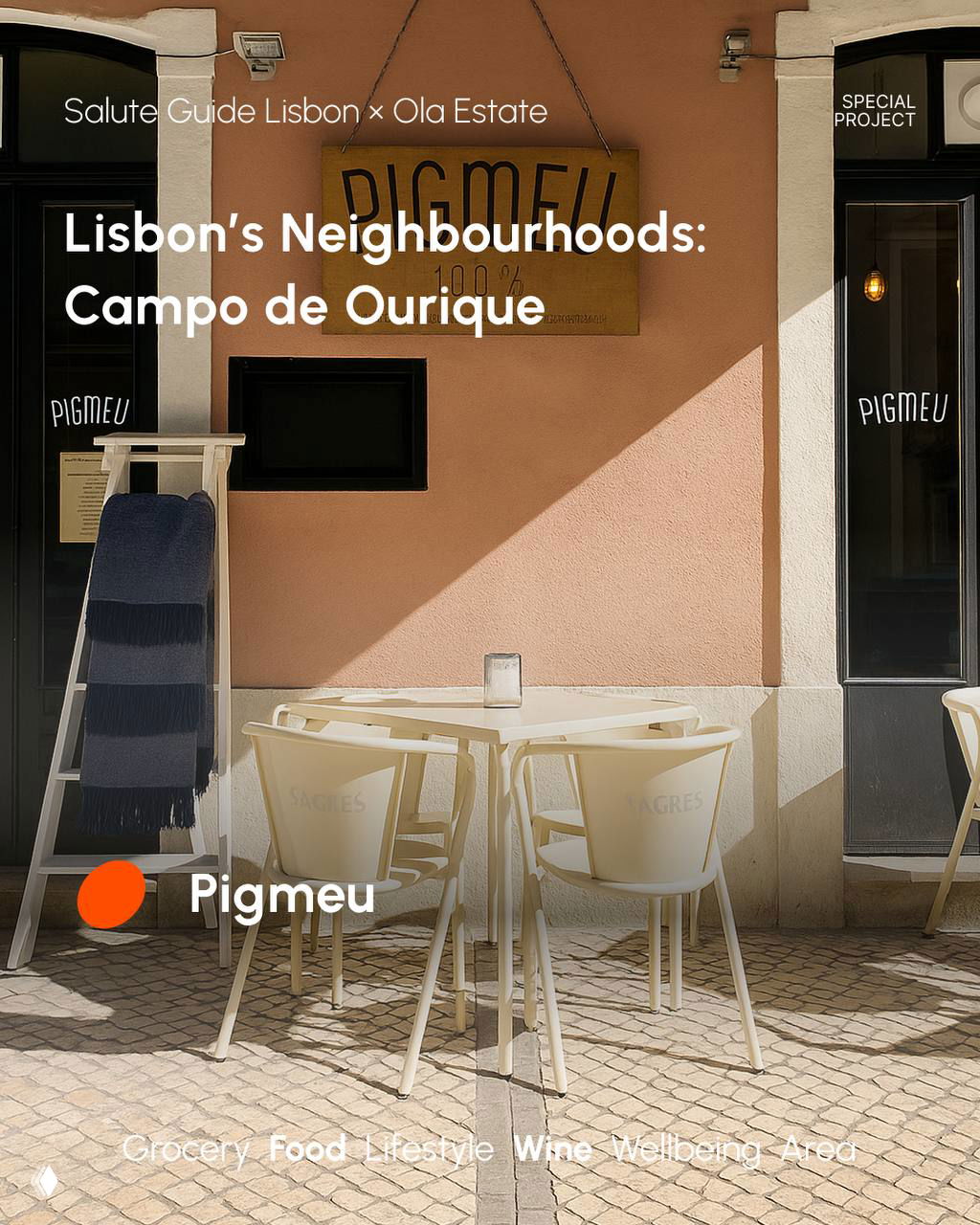 Sunlit exterior of Pigmeu café in Campo de Ourique showing empty outdoor chairs, a pale pink facade and a small terrace table.