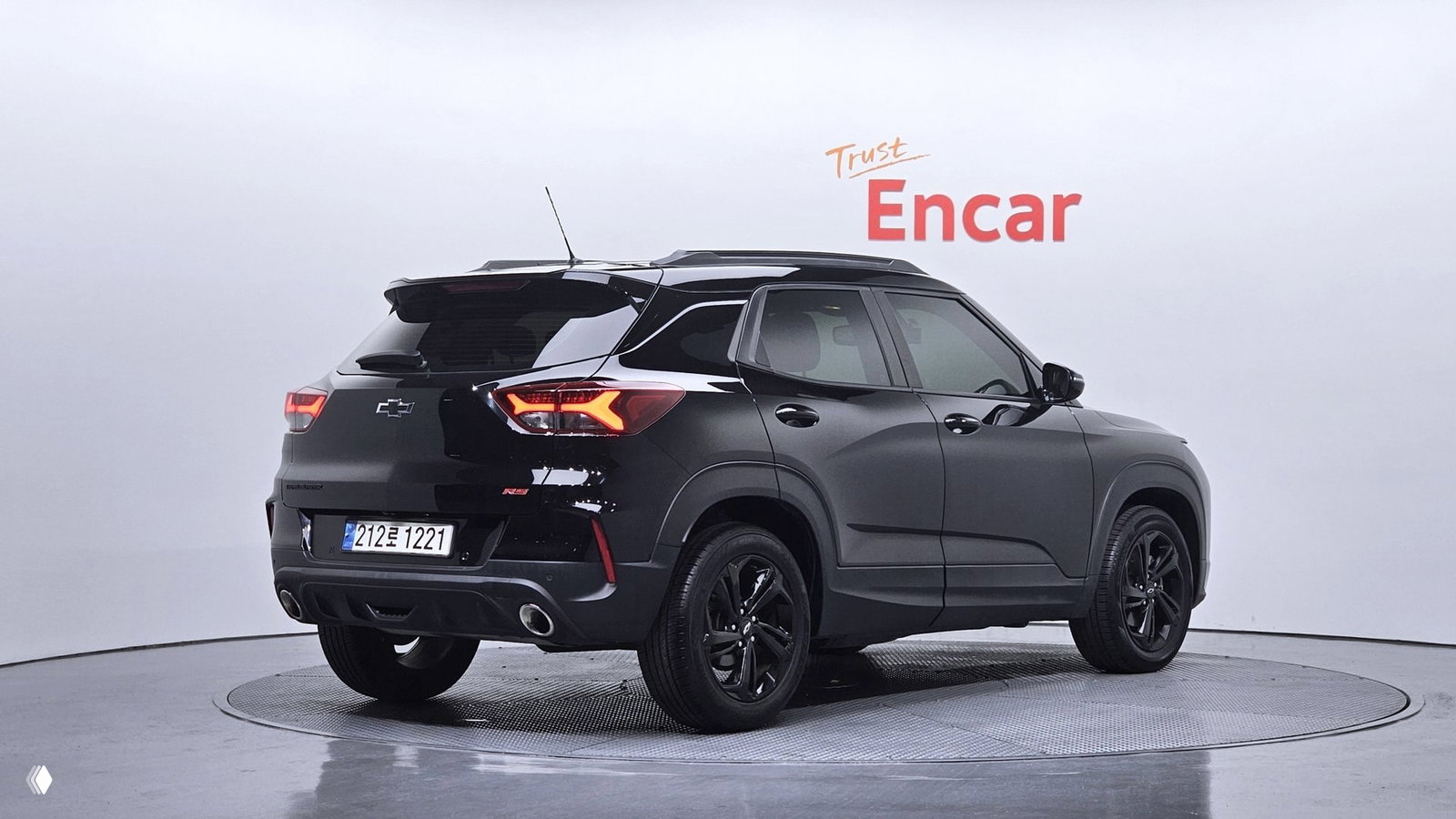 Вид сзади и профиль чёрного Chevrolet Trailblazer RS 2021 в студии ENCAR: задние фонари, бампер, двойная выхлопная насадка и общий силуэт кроссовера на поворотном подиуме.