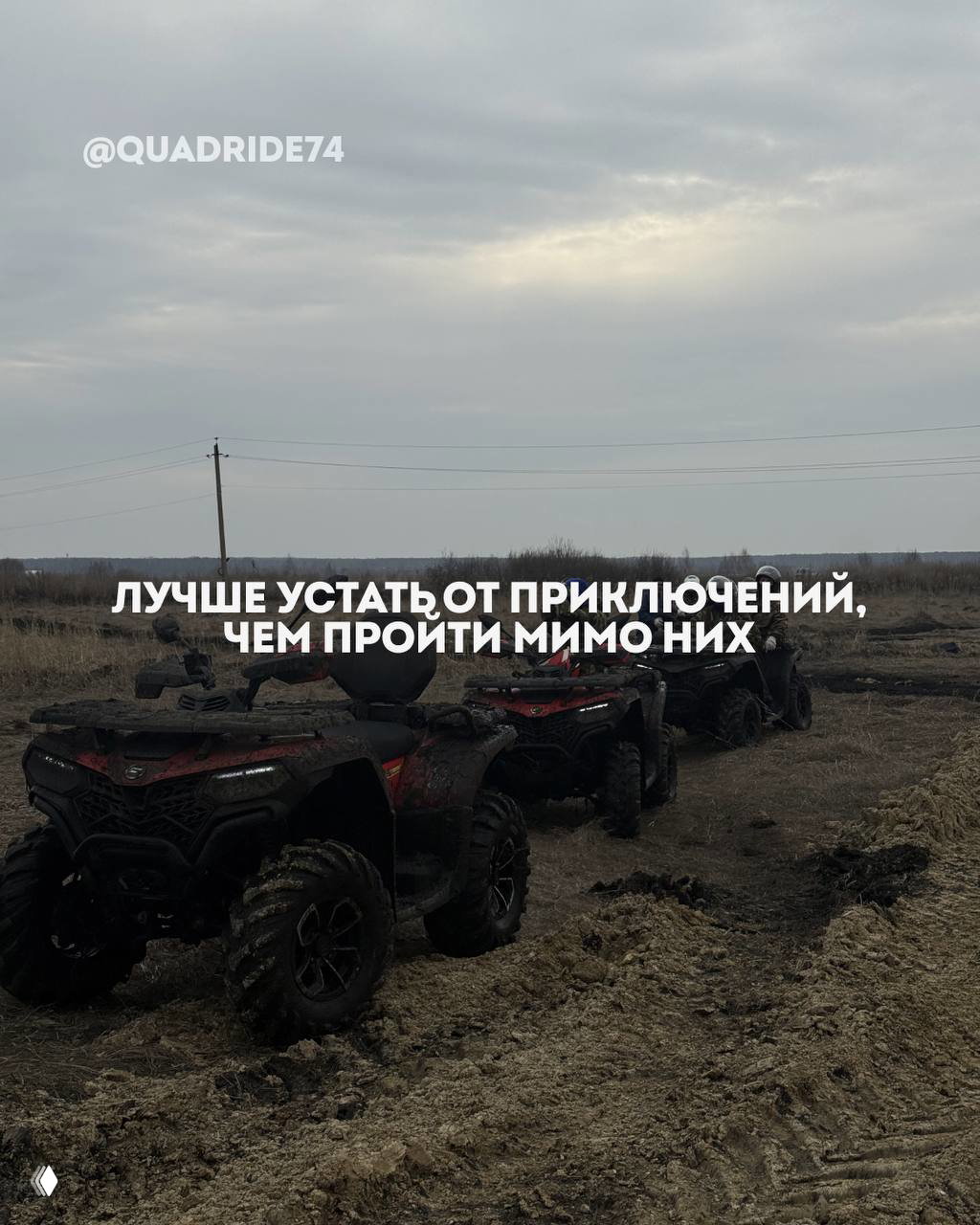 Несколько квадроциклов выстроены в ряд на размытой грязевой трассе, вокруг поле и линия горизонта под серым небом.