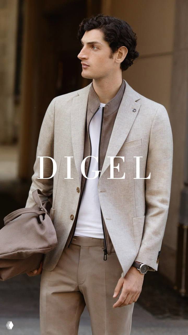 Мужчина в бежево-сером пиджаке и свободных брюках DIGEL держит сумку; кадр подчёркивает функциональность, текстуру тканей и спокойную палитру коллекции.