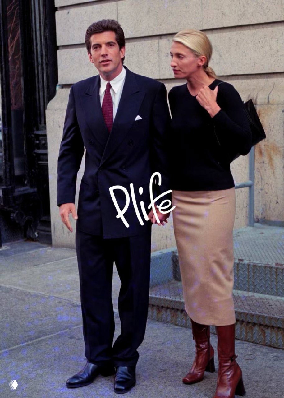 Пара идёт по тротуару: мужчина в тёмном пиджаке и женщина в юбке и сапогах; кадр демонстрирует сочетание классики и повседневности в образе.