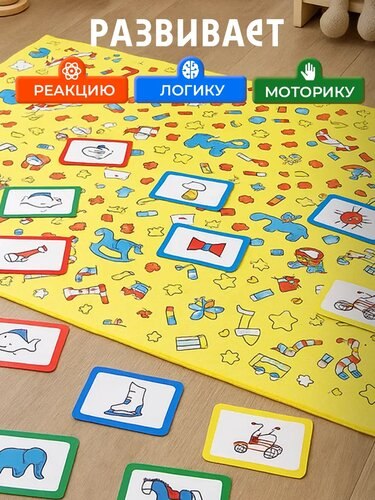 Жёлтое текстильное поле с разложенными карточками игры: на поле простые рисунки, карта и элементы для развития логики и моторики у ребёнка.