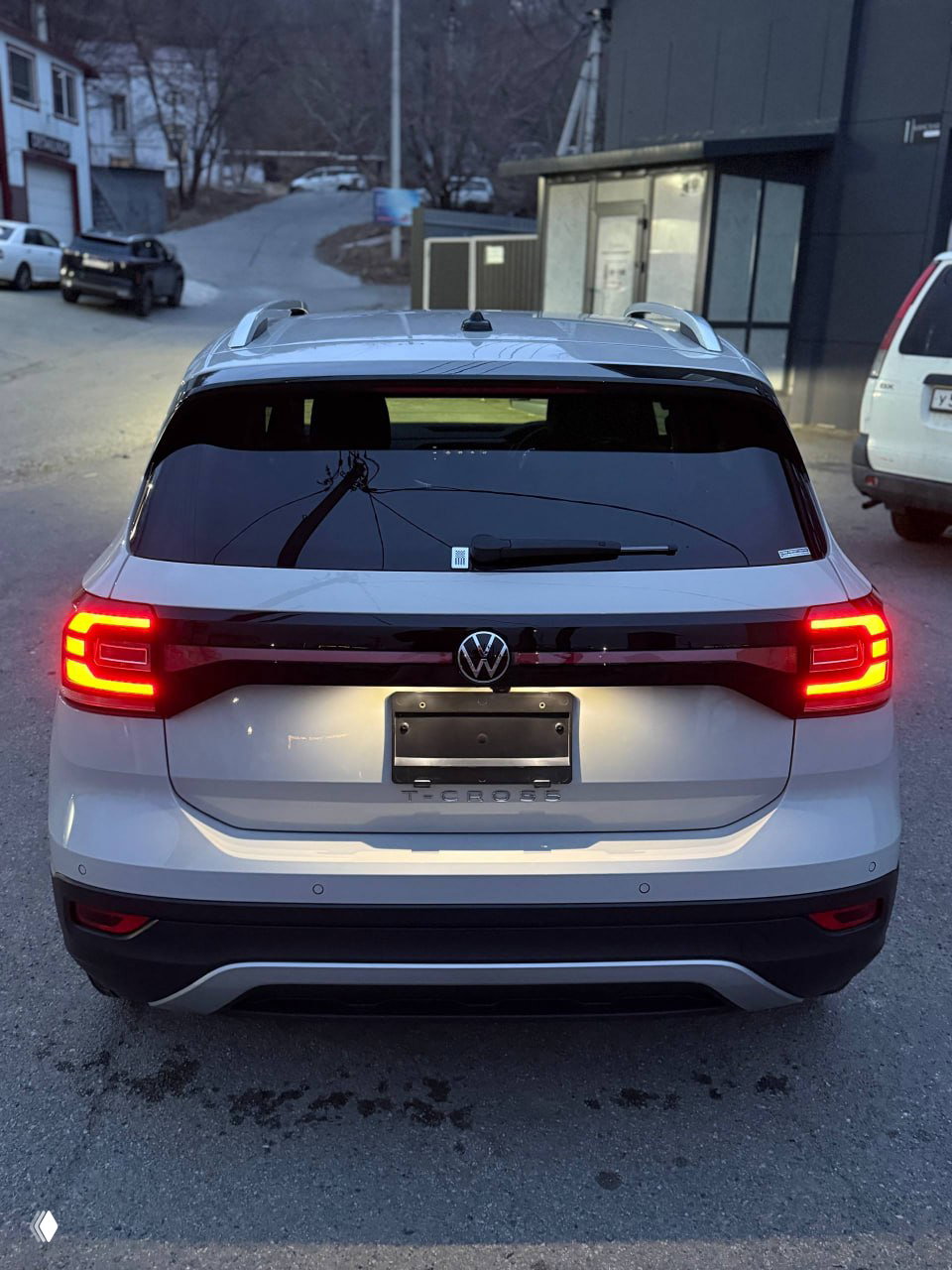 Профиль Volkswagen T‑Cross на ровной площадке: вид сбоку показывает ровный лакокрасочный слой и заводские линии кузова у машины 2023-го года.