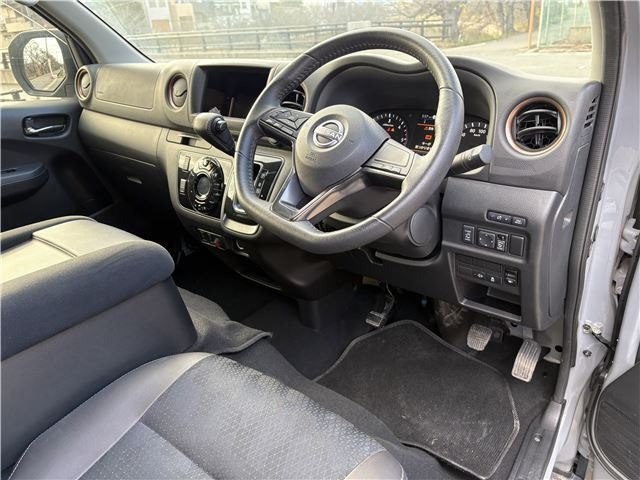 Салон Nissan Caravan: вид на руль, переднюю панель и водительское место, состояние обивки и приборной панели видно на фото.